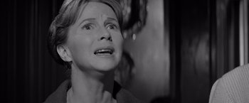 Movie still from “The Haunting” (1963), directed by Robert Wise – An older woman is crying with her eyes wide open; Close Up shot, Over the shoulder angle