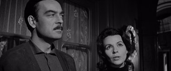 Movie still from “The Haunting” (1963), directed by Robert Wise – A man and a woman standing next to each other; Close Up shot, Low angle