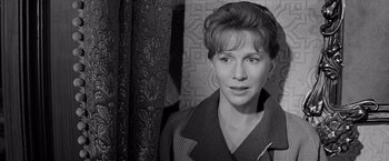 Movie still from “The Haunting” (1963), directed by Robert Wise – Black and white photograph of a woman in front of a wall; Close Up shot, Over the shoulder angle