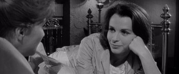 Movie still from “The Haunting” (1963), directed by Robert Wise – A black - and - white photo of a woman sitting on a couch; Close Up shot, High angle