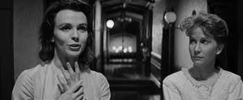 Movie still from “The Haunting” (1963), directed by Robert Wise – A black - and - white photo of a woman and a man in a hallway; Close Up shot, Over the shoulder angle