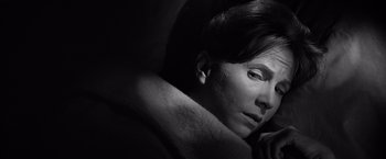 Movie still from “The Haunting” (1963), directed by Robert Wise – A man with a shaved head is looking into the distance; Close Up shot, High angle