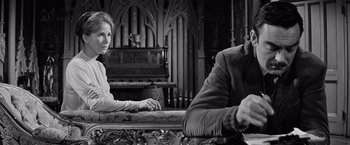 Movie still from “The Haunting” (1963), directed by Robert Wise – A man and a woman sitting in front of an organ; Medium shot, Low angle