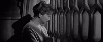 Movie still from “The Haunting” (1963), directed by Robert Wise – A black and white photo of a woman looking down; Close Up shot, Low angle