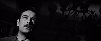 Movie still from “The Haunting” (1963), directed by Robert Wise – A black and white photo of a man's face in the dark; Close Up shot, Low angle