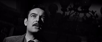 Movie still from “The Haunting” (1963), directed by Robert Wise – A black and white photo of a man with a mustache; Close Up shot, Low angle