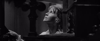 Movie still from “The Haunting” (1963), directed by Robert Wise – A black - and - white photo of a woman looking up; Close Up shot, Low angle