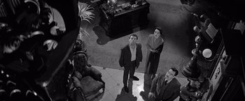 Movie still from “The Haunting” (1963), directed by Robert Wise – A black and white photo of a group of people standing around; Wide shot, High angle