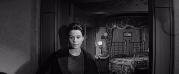 Movie still from “The Haunting” (1963), directed by Robert Wise – A black and white photo of a woman in a room; Medium shot, High angle