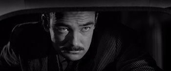 Movie still from “The Haunting” (1963), directed by Robert Wise – A black and white photo of a man with a mustache; Close Up shot, Low angle