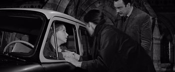 Movie still from “The Haunting” (1963), directed by Robert Wise – A man and a woman in the back of a car; Medium shot, High angle