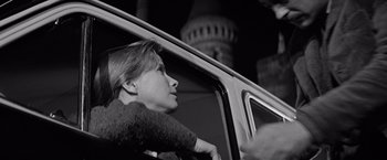Movie still from “The Haunting” (1963), directed by Robert Wise – A woman sitting in the driver's seat of a car; Close Up shot, Low angle