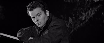 Movie still from “The Haunting” (1963), directed by Robert Wise – Black and white photograph of a man in a jacket; Close Up shot, Low angle