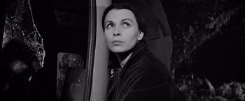 Movie still from “The Haunting” (1963), directed by Robert Wise – Black and white photograph of a woman looking out a window; Close Up shot, High angle