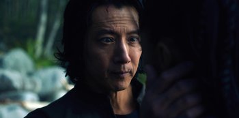 Movie still from “Altered Carbon” (2018), created by Laeta Kalogridis – A person wearing a black shirt; Close Up shot, Over the shoulder angle