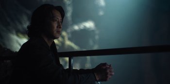 Movie still from “Altered Carbon” (2018), created by Laeta Kalogridis – A man sitting on a ledge looking out of a window; Close Up shot, Over the shoulder angle