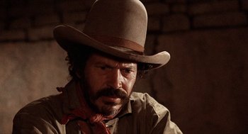 Movie still from “The Hired Hand” (1971), directed by Peter Fonda – A man with a hat and a neck tie; Close Up shot, Low angle