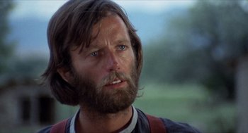 Movie still from “The Hired Hand” (1971), directed by Peter Fonda – A person with long hair and a beard; Close Up shot, Low angle