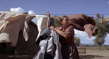 Movie still from “The Hired Hand” (1971), directed by Peter Fonda – A woman hanging clothes on a clothes line; Wide shot, Low angle