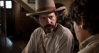 Movie still from “The Hired Hand” (1971), directed by Peter Fonda – A person wearing a hat; Close Up shot, Over the shoulder angle