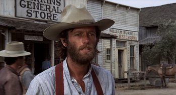 Movie still from “The Hired Hand” (1971), directed by Peter Fonda – A man in a cowboy hat standing in front of a store; Close Up shot, Low angle