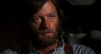 Movie still from “The Hired Hand” (1971), directed by Peter Fonda – A person with a beard; Close Up shot, Over the shoulder angle