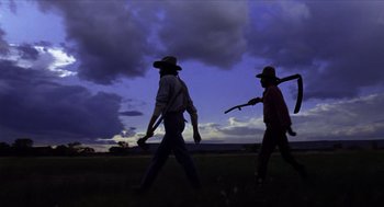 Movie still from “The Hired Hand” (1971), directed by Peter Fonda – A group of men walking across a field at night; Wide shot, Low angle