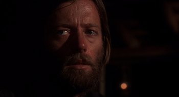 Movie still from “The Hired Hand” (1971), directed by Peter Fonda – A person with a beard looking at the camera; Close Up shot, Low angle