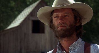 Movie still from “The Hired Hand” (1971), directed by Peter Fonda – A man with a beard and a cowboy hat; Close Up shot, Low angle