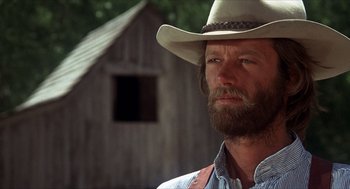 Movie still from “The Hired Hand” (1971), directed by Peter Fonda – A man with a beard and a cowboy hat; Close Up shot, Low angle