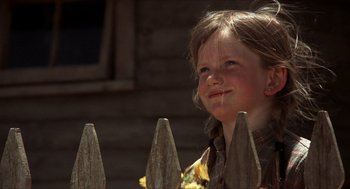 Movie still from “The Hired Hand” (1971), directed by Peter Fonda – A little girl standing next to a wooden picket fence; Close Up shot, Low angle