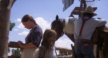 Movie still from “The Hired Hand” (1971), directed by Peter Fonda – A woman and two girls standing next to a horse; Wide shot, Low angle