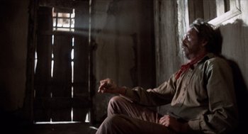 Movie still from “The Hired Hand” (1971), directed by Peter Fonda – An old man sitting in a chair in a room; Medium shot, Low angle