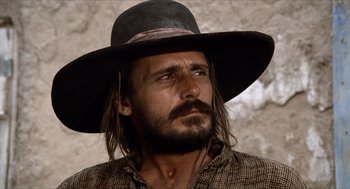 Movie still from “The Hired Hand” (1971), directed by Peter Fonda – A person wearing a hat; Close Up shot, Low angle