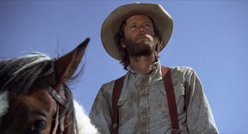 Movie still from “The Hired Hand” (1971), directed by Peter Fonda – A man with a cowboy hat on a horse; Close Up shot, Low angle