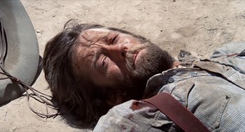 Movie still from “The Hired Hand” (1971), directed by Peter Fonda – A man laying on the ground in the dirt; Close Up shot, High angle