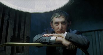 A man leaning up against a railing looking into the distance