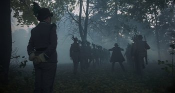 Movie still from “The Hourglass Sanatorium” (1973), directed by Wojciech Has – A group of people walking through a foggy forest; Wide shot, High angle