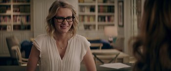 Movie still from “The House” (2017), directed by Andrew Jay Cohen – A woman wearing glasses and a white shirt; Close Up shot, Over the shoulder angle