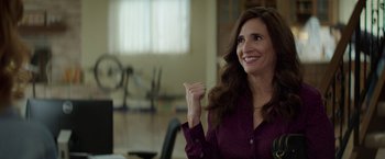 Movie still from “The House” (2017), directed by Andrew Jay Cohen – A woman in a purple shirt is holding her hands up; Close Up shot, Over the shoulder angle