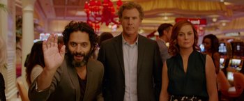 Movie still from “The House” (2017), directed by Andrew Jay Cohen – Two men standing next to each other in a room; Medium shot, Over the shoulder angle