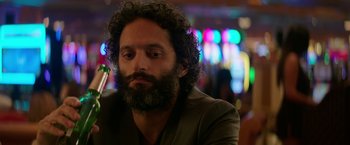 Movie still from “The House” (2017), directed by Andrew Jay Cohen – A man with a beard is sitting at a table; Close Up shot, Over the shoulder angle