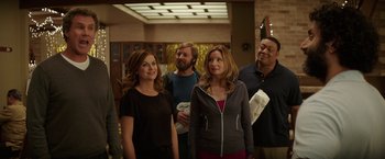 Movie still from “The House” (2017), directed by Andrew Jay Cohen – A group of people standing next to each other in a room; Medium shot, Over the shoulder angle