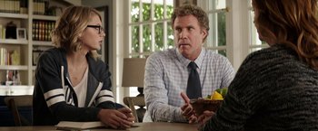 Movie still from “The House” (2017), directed by Andrew Jay Cohen – A man and a woman sitting at a table talking to another man; Medium shot, Over the shoulder angle