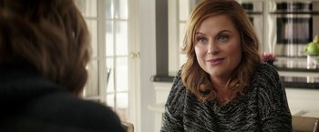 Movie still from “The House” (2017), directed by Andrew Jay Cohen – A person sitting in a room; Close Up shot, Over the shoulder angle