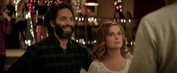 Movie still from “The House” (2017), directed by Andrew Jay Cohen – A man and a woman standing next to each other in front of lights; Close Up shot, Over the shoulder angle