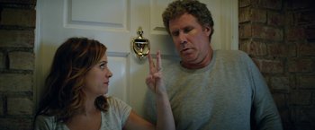 Movie still from “The House” (2017), directed by Andrew Jay Cohen – A man and a woman standing next to each other in front of a door; Medium shot, Over the shoulder angle