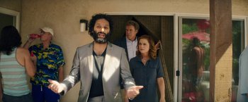 Movie still from “The House” (2017), directed by Andrew Jay Cohen – A group of people standing next to each other in front of a door; Medium shot, Over the shoulder angle