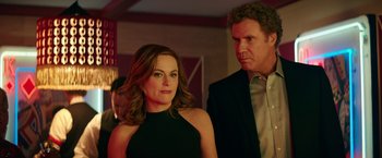 Movie still from “The House” (2017), directed by Andrew Jay Cohen – A man and a woman standing next to each other; Medium shot, Over the shoulder angle