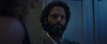 Movie still from “The House” (2017), directed by Andrew Jay Cohen – A man with a beard is looking at the camera; Close Up shot, Low angle